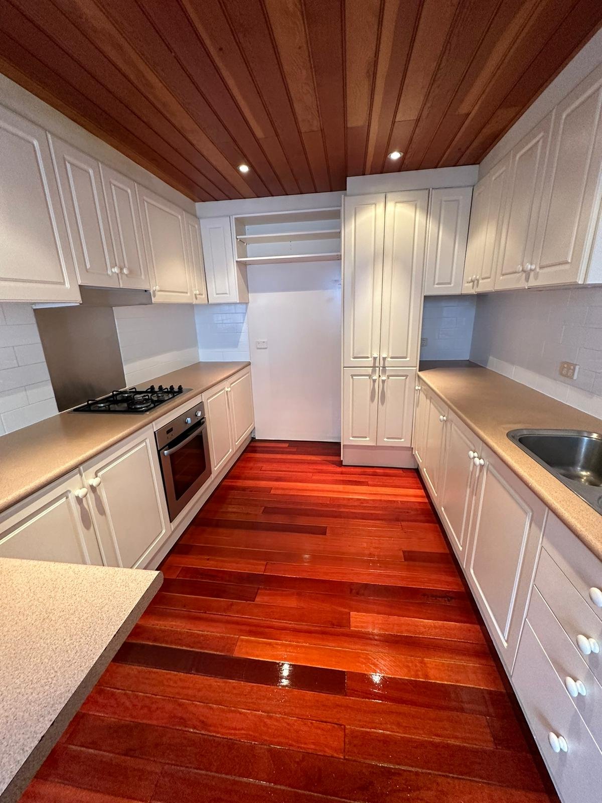 Professional deep kitchen cleaning in Sydney showing spotless countertops and hardwood floors.
